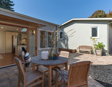 Backyard patio with a table and four chairs